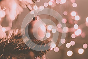 Closeup of a decorative ornament hanging from the Christmas tree covered with lights