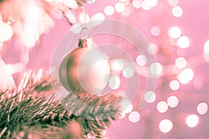 Closeup of a decorative ornament hanging from the Christmas tree covered with lights