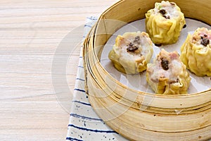 Closeup of delicious Chinese shumai dumplings on a xiaolong bamboo steaming basket