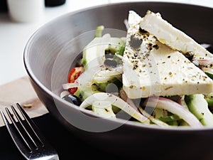 Closeup delicious Greek salad with fresh vegetables and feta cheese