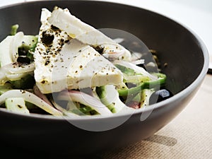 Closeup delicious Greek salad with fresh vegetables and feta cheese