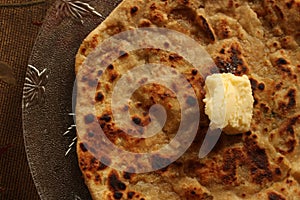 Delicious and nutritious Alu Paratha with pasteurized butter photo