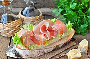 Closeup of delicious parma ham sandwich on wooden backgraund table