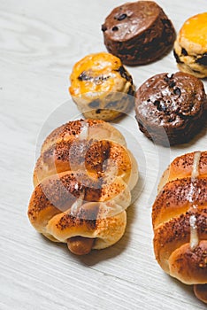 Closeup delicious sausage bread roll and fresh tasty scones on w