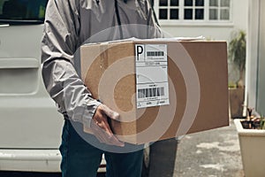 Closeup, delivery and man with box, courier and doorway with ecommerce work, distribution service and logistics. Person