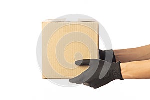 Closeup delivery man hand in medical gloves holding cardboard box isolated on white background
