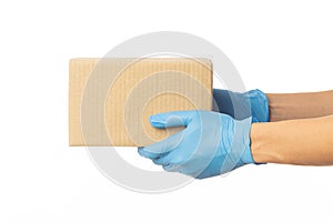 Closeup delivery man hand in medical gloves holding cardboard box isolated on white background