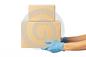 Closeup delivery man hand in medical gloves holding cardboard boxes isolated on white background