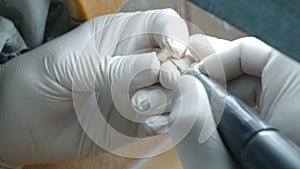 Closeup of a dental technician making of denture in a dental lab