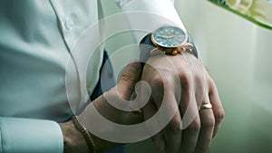 Closeup designer watch on businessman hand. Clip. Hand of businessman with a clock