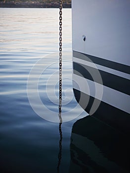 Closeup detail of anchor rope metal chain in calm water mediterranean sea Mallorca Majorca Balearic Islands Spain Europe