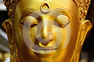 Closeup detail of golden buddha statue