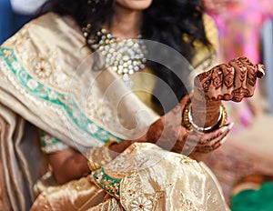 Closeup detail of an Indian bride wearing beautiful colorful garments
