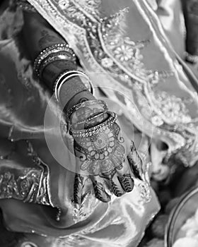 Black and white closeup detail of an Indian bride wearing beautiful colorful garments