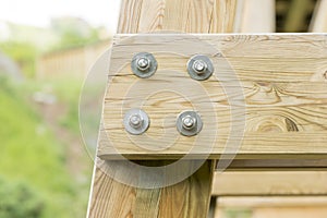 Closeup detail of new wooden beams fastened with bolts.