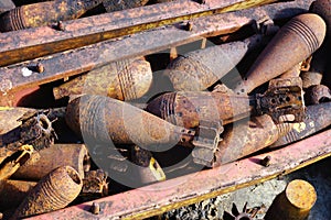 Closeup detail of a pile of rusty grenades, bombs and unexploded ordnance in rural Laos