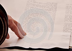 Closeup detail of a Rabbi writing a Torah manuscript scroll