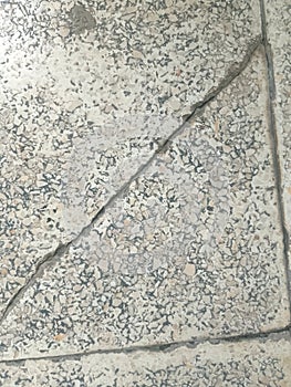 closeup detail of the surface of an old ceramic tile or tile floor