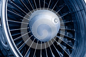 Closeup detail of turbine airplane engine blades, toning blue color