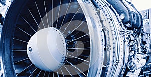 Closeup detail of turbine airplane engine blades, toning blue color