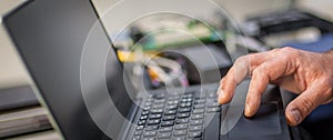 Closeup detail view of laptop computer. Engineer inspect electric system