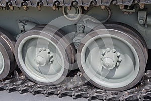 Closeup detailed view of a armoured tank track with belt and roadwheels