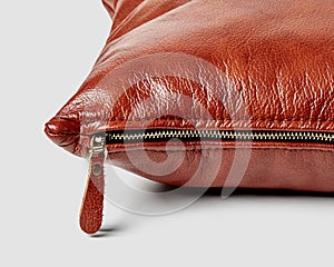 Closeup detailed view of brown leather couch cushion with side zipper