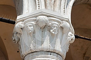 Closeup details shot of the sixteenth column capital of the Doge Palace in Venice photo