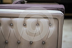 Closeup of a diamond tufting of a leather sofa