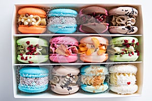 Closeup of different colors macarons cakes. Sweet almond colorful pastel pink blue yellow green macaron.