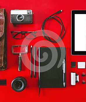 Closeup of different photography objects on red background.