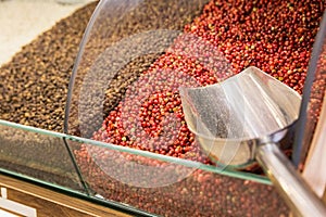 Closeup of different spices on oriental spice sale market. Red and black peppercorn