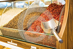 Closeup of different spices on oriental spice sale market. Red and black peppercorn