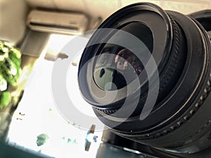 Closeup of digital camera lens side view,blurred background,photography equipment