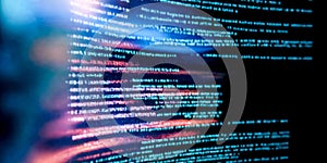 Closeup digital code on computer screen. Lines of programming language visible, technology, cybersecurity concepts. Colors range