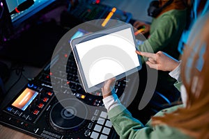 Closeup digital tablet over sound mixer