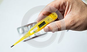 Closeup of Digital thermometer in the hand