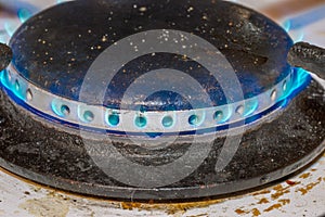 Closeup on dirty gas burner on a kitchen stove