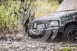 Closeup of dirty off-road car with splashes of mud.