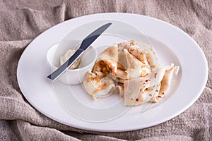 Closeup dish with pancakes and knife and butter