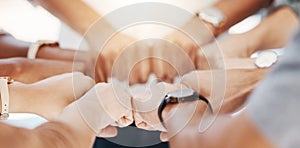 Closeup of diverse group of people making fists in a circle to express unity, support and solidarity. Hands of