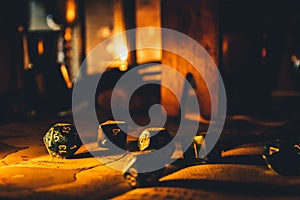 Closeup of dnd dice set in warm lights on a blurry background