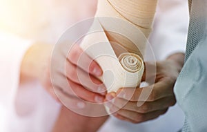 Closeup.doctor applying elastic bandage