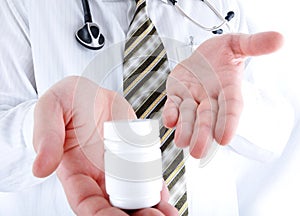 Closeup, doctor holding little pills bottle