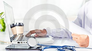 Doctor woman typing information of patient prescription from paperwork medical history form into laptop