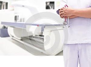 Closeup doctor in white uniform gown coat hand holding stethoscope in clinic hospital and Bone densitometer in room