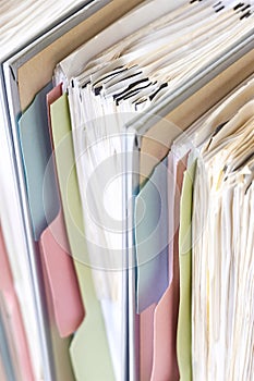Closeup of document binders with papers and tabs