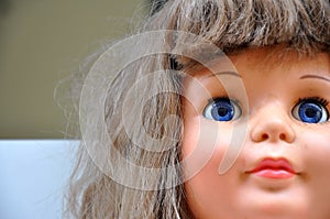 Closeup of doll face, doll face in zoom, with details of eyes, mouth, nose in zoom with selective focus on eyes