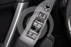 closeup of a door control panel in a new car.
