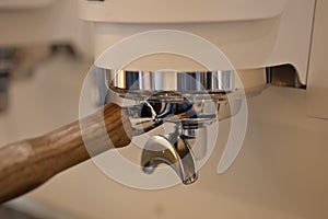 Closeup of double spout portafilter holder in espresso machinge group head